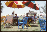 Unidentified Men Sitting Under Umbrellas by Rhode Island College