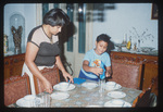 Unidentified Woman and Child Setting Table by Rhode Island College